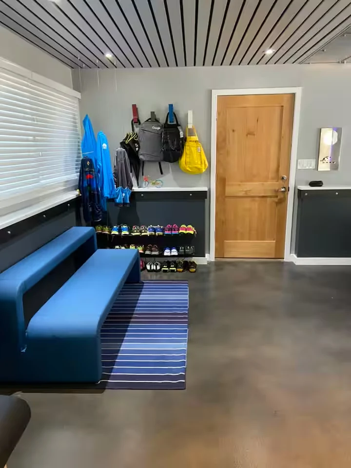 Recreation gear station with blue bench, shoe rack and colorful hanging bags